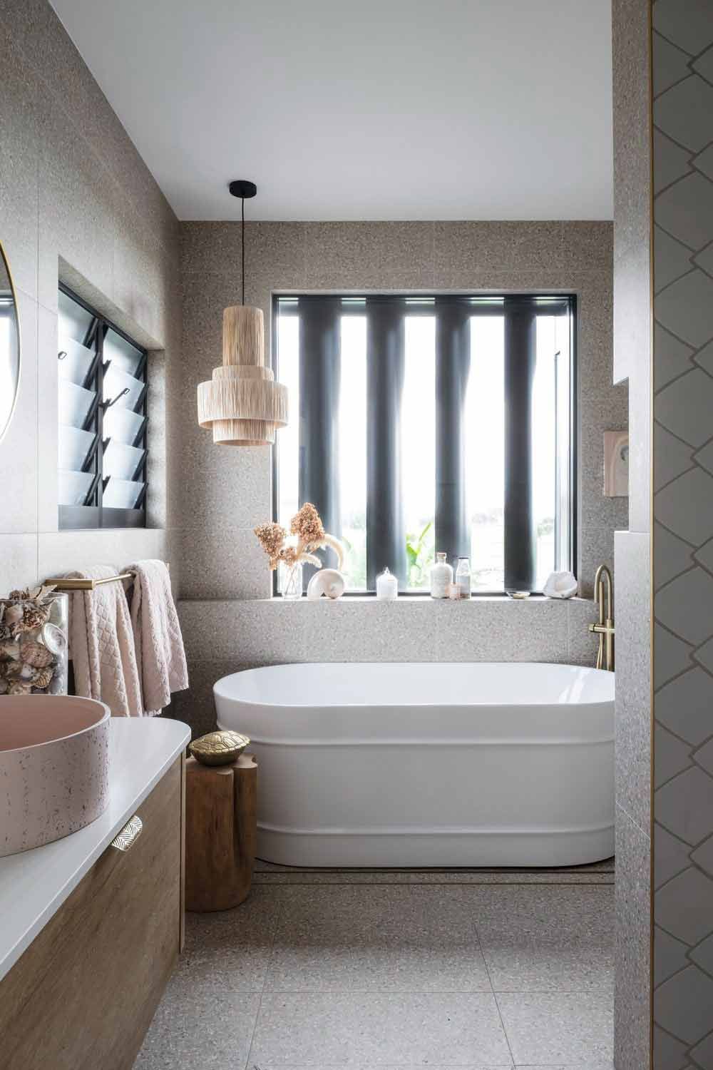 A Bathroom With a Tub, Sink, Mirror and Window — DeBu Studios In Russell Vale, NSW