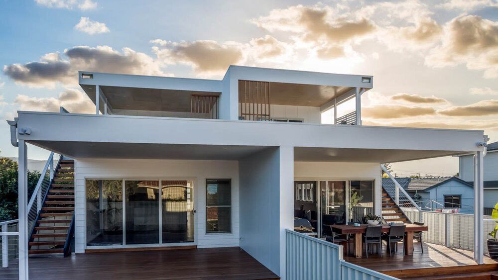 A Large White House With a Large Deck and Stairs — DeBu Studios In Russell Vale, NSW