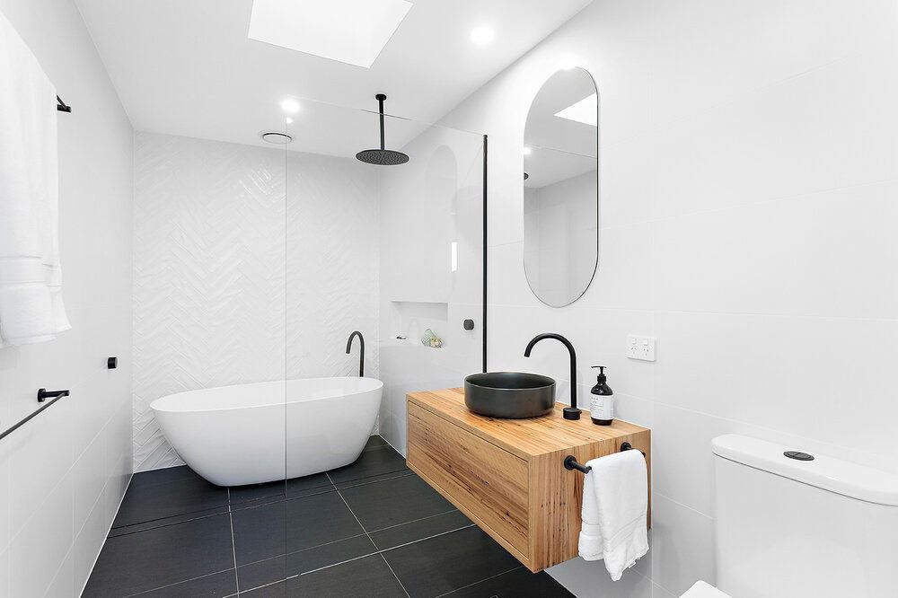 A Bathroom With a Bathtub, Sink, Toilet and Shower — DeBu Studios In Russell Vale, NSW