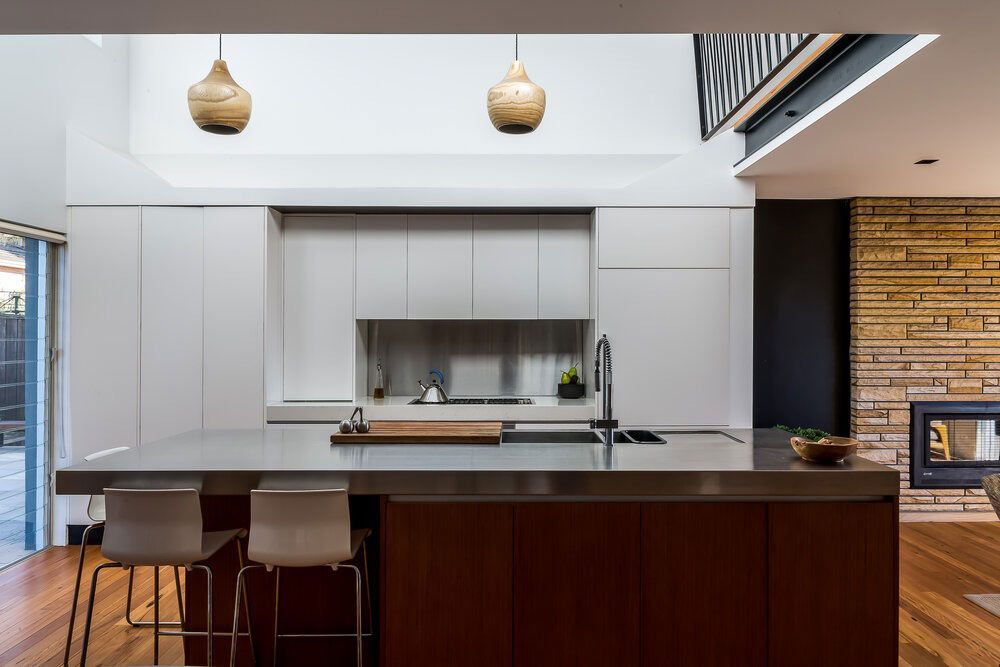 A Kitchen With a Large Island and Stainless Steel Counter Tops — DeBu Studios In Russell Vale, NSW
