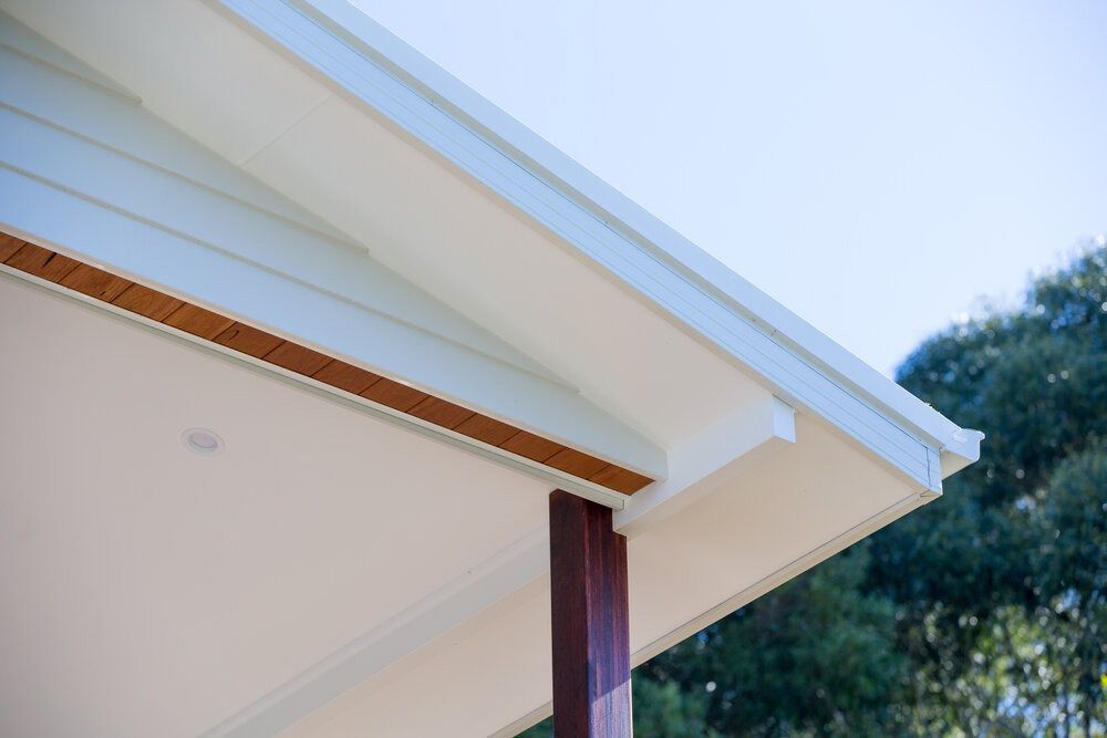 A Close Up of the Roof of a House With Trees in the Background — DeBu Studios In Russell Vale, NSW