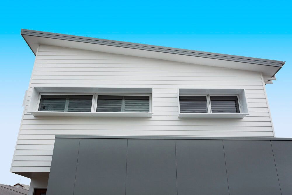 A White House With a Blue Sky in the Background — DeBu Studios In Russell Vale, NSW