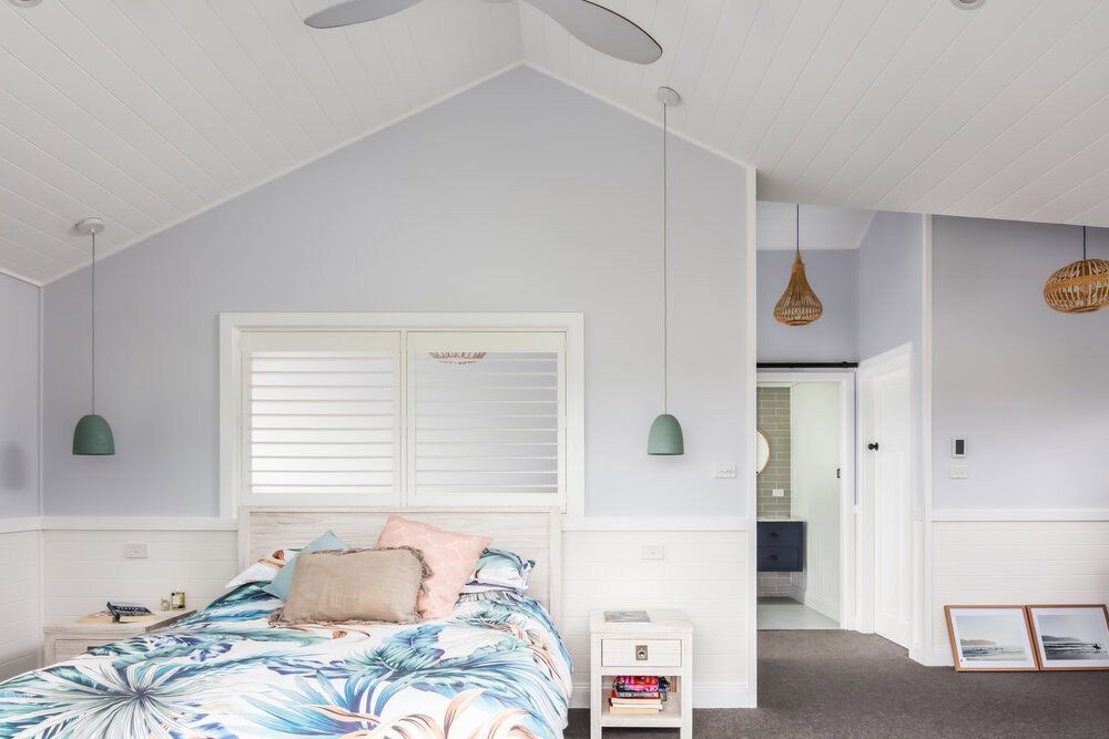 A Bedroom With a Bed, Nightstand, and Ceiling Fan — DeBu Studios In Russell Vale, NSW