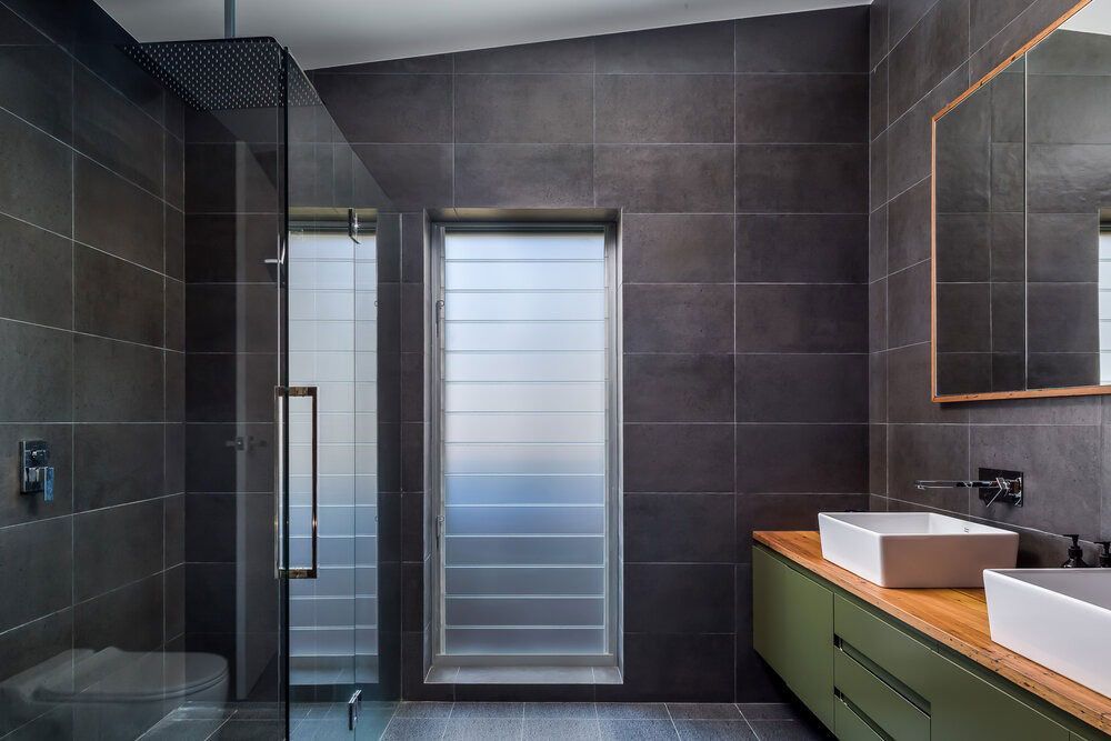 A Bathroom With Two Sinks, a Toilet and a Shower — DeBu Studios In Russell Vale, NSW