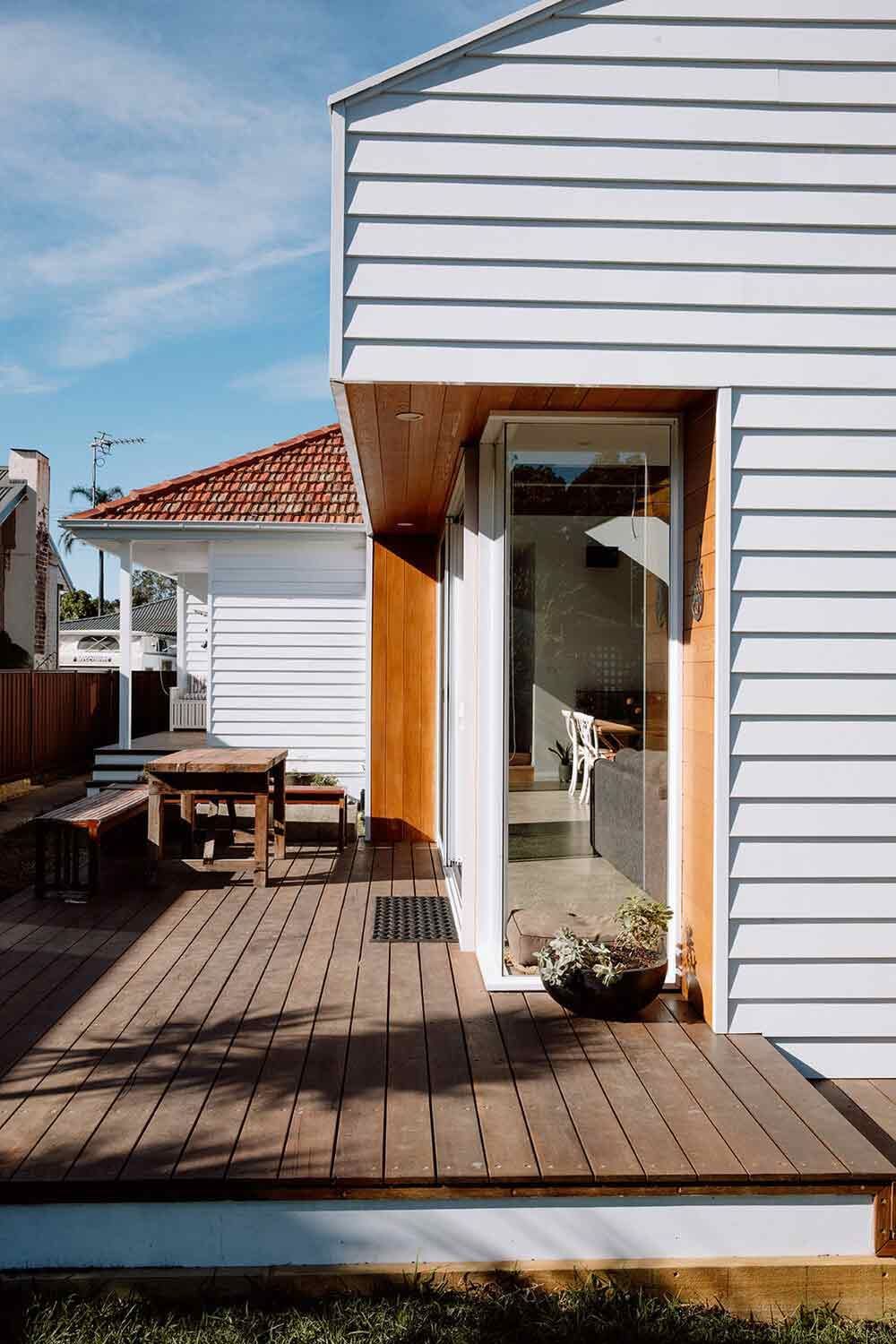 A White House With a Wooden Deck in Front of It — DeBu Studios In Russell Vale, NSW