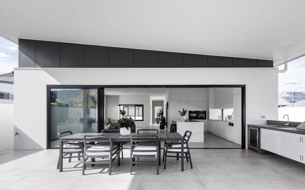 There is a Table and Chairs on the Patio of a House — DeBu Studios In Russell Vale, NSW