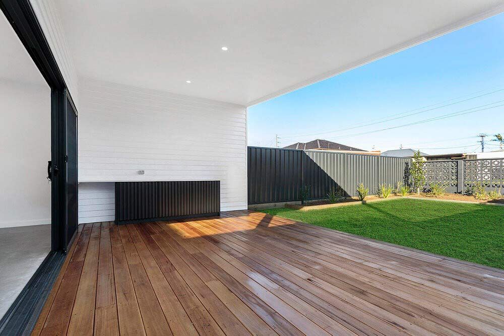 There is a Wooden Deck With a Fence in the Background — DeBu Studios In Russell Vale, NSW