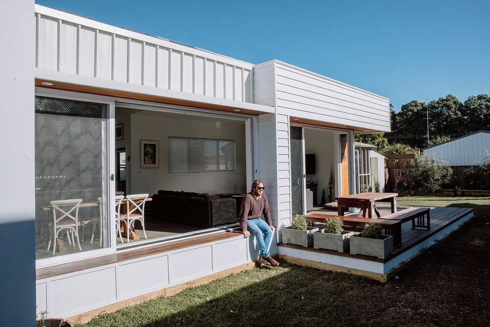 A Man is Sitting on the Porch of a House — DeBu Studios In Russell Vale, NSW