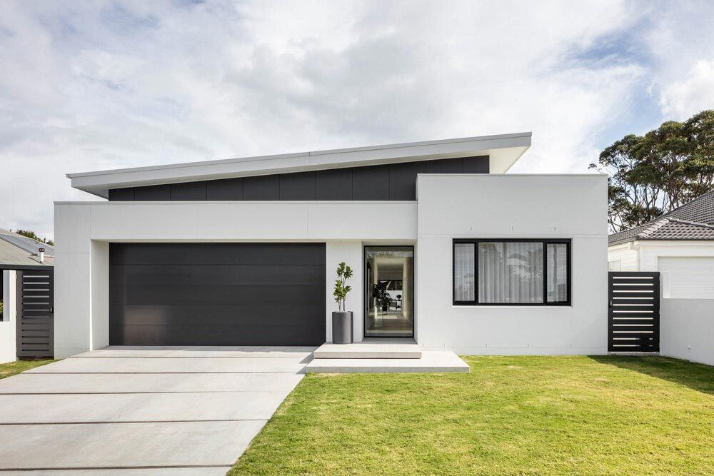 A Modern White and Black House With a Black Garage Door — DeBu Studios In Russell Vale, NSW