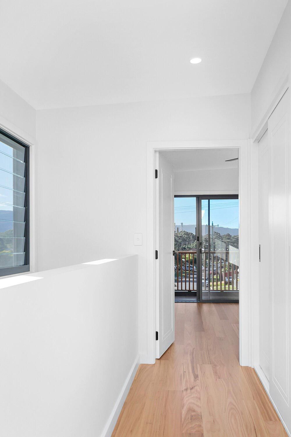 A Hallway in a House With Hardwood Floors and White Walls — DeBu Studios In Russell Vale, NSW