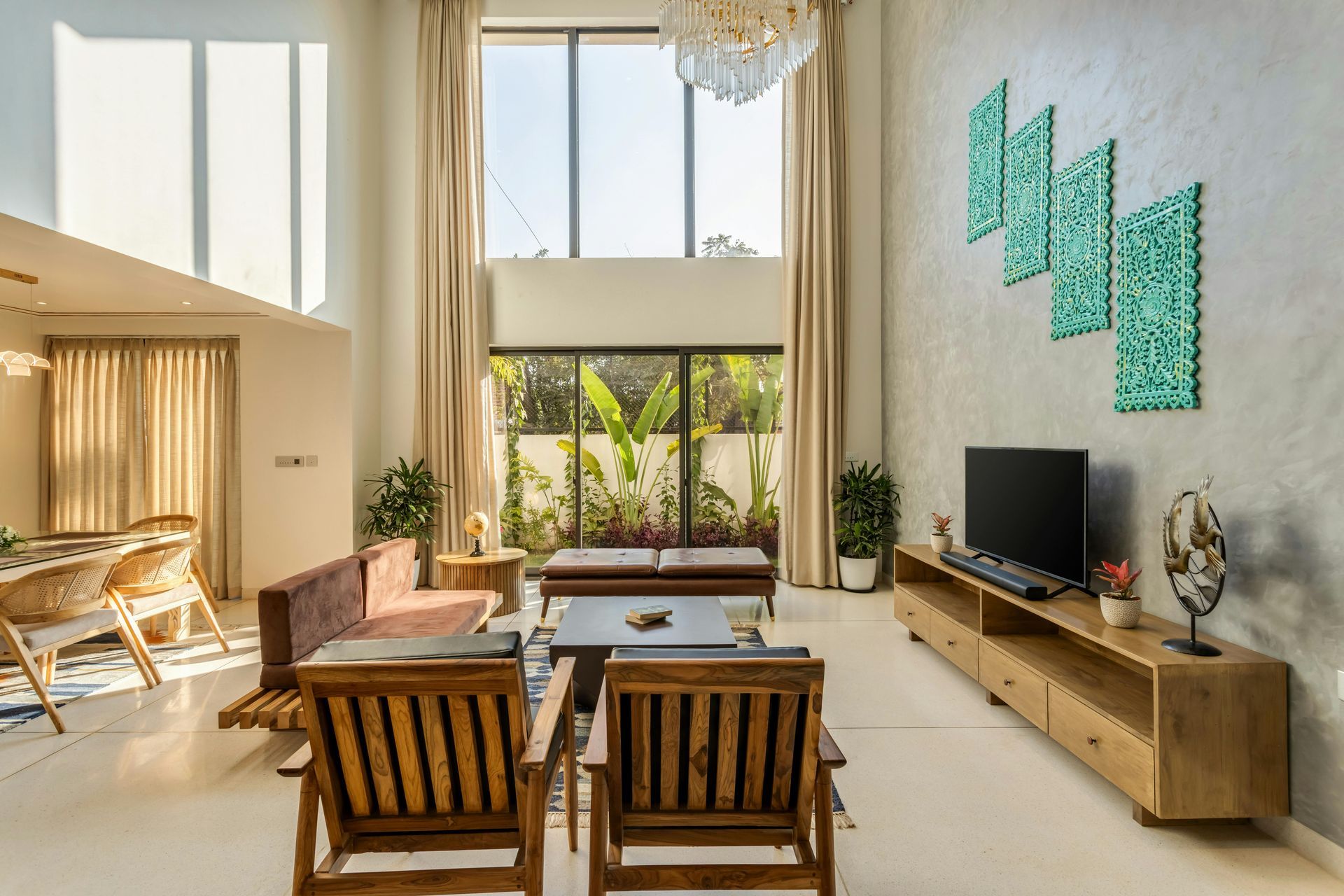 Living room with high ceilings, wooden furniture, large windows, and a turquoise wall art piece.