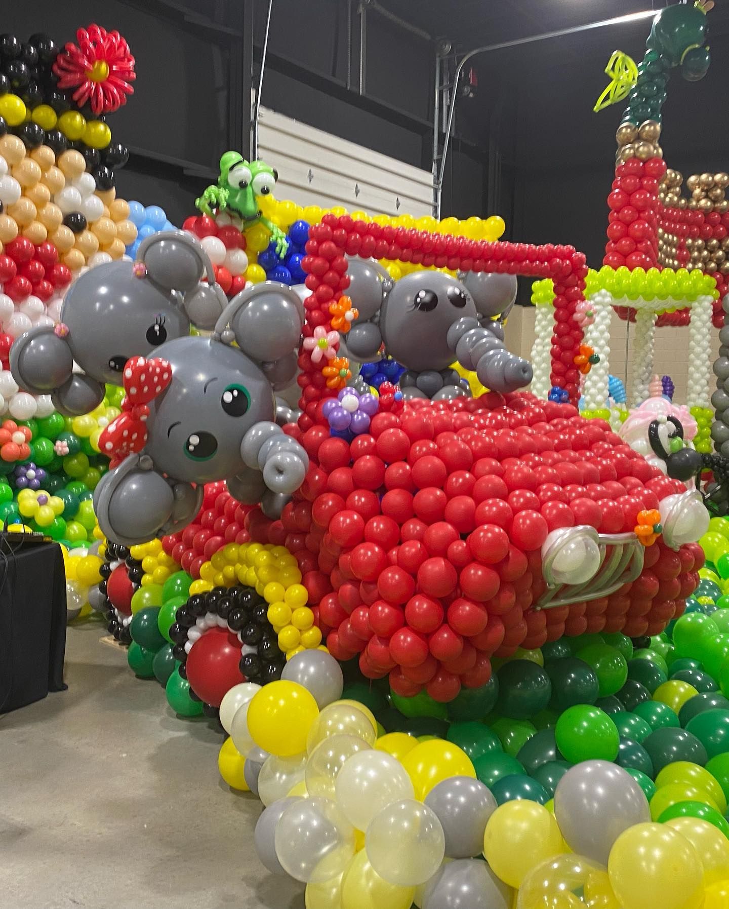 A car made out of balloons with elephants in it