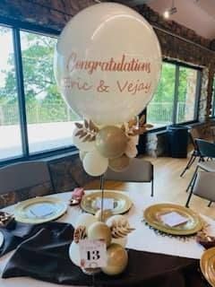 A congratulations balloon is sitting on top of a table.