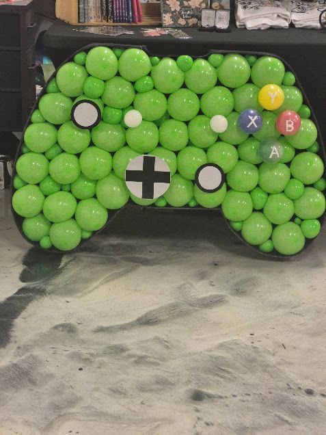 Green balloon Xbox controller decoration with colored button details.