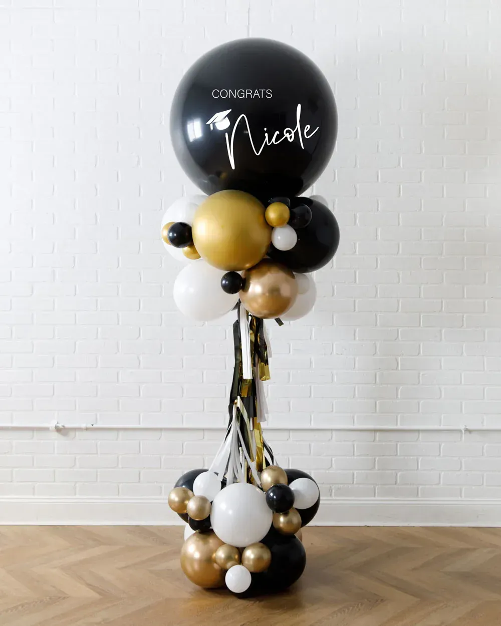 A bunch of balloons are sitting on top of a wooden floor.