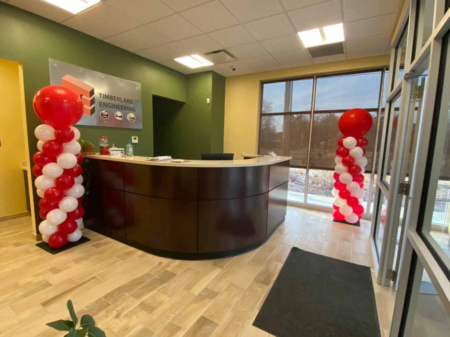 A reception area decorated with red and white balloons