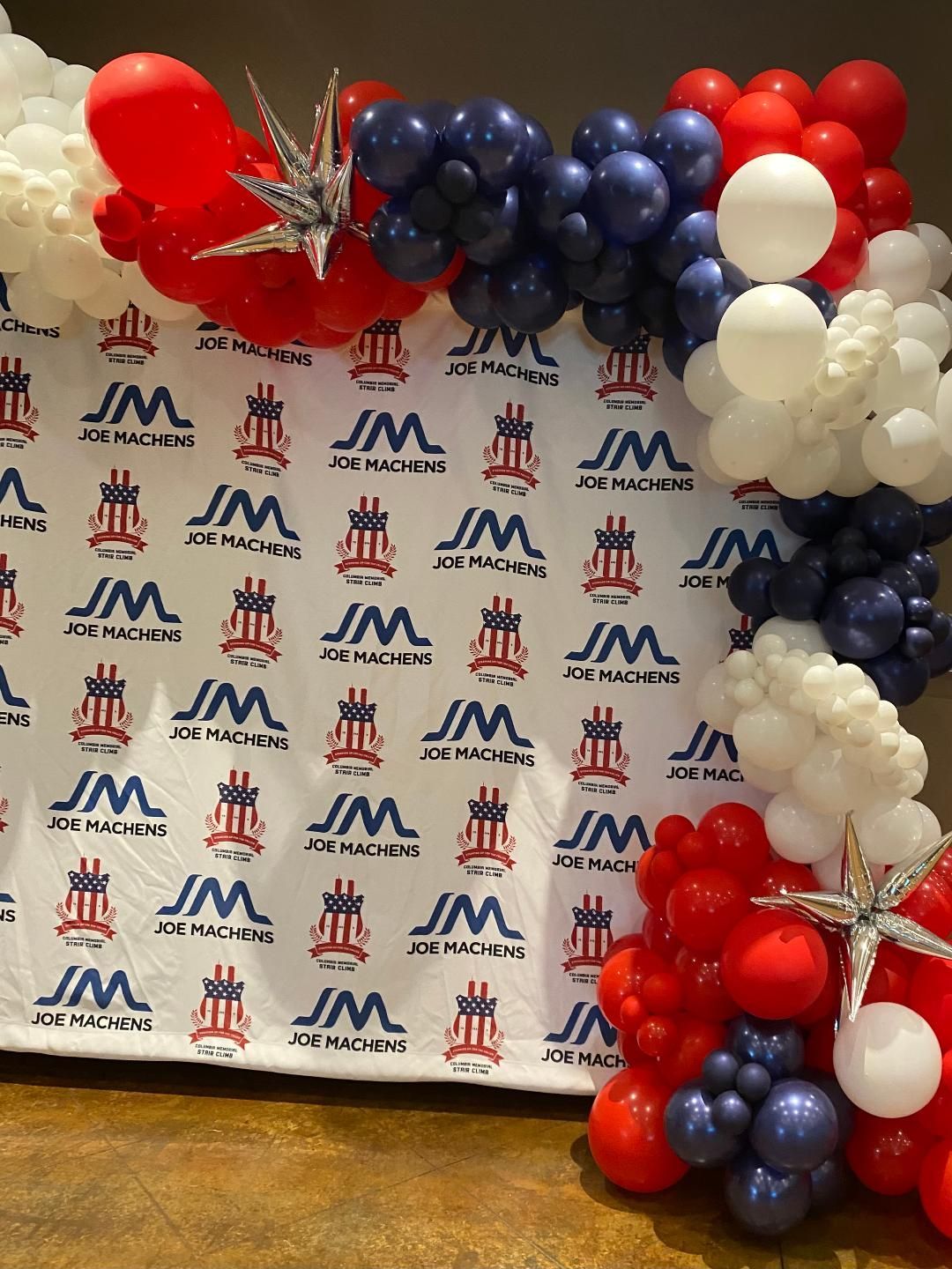 A table with red , white and blue balloons on it