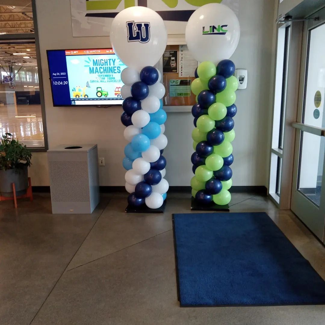 Blue and green balloons with the letter lj on them