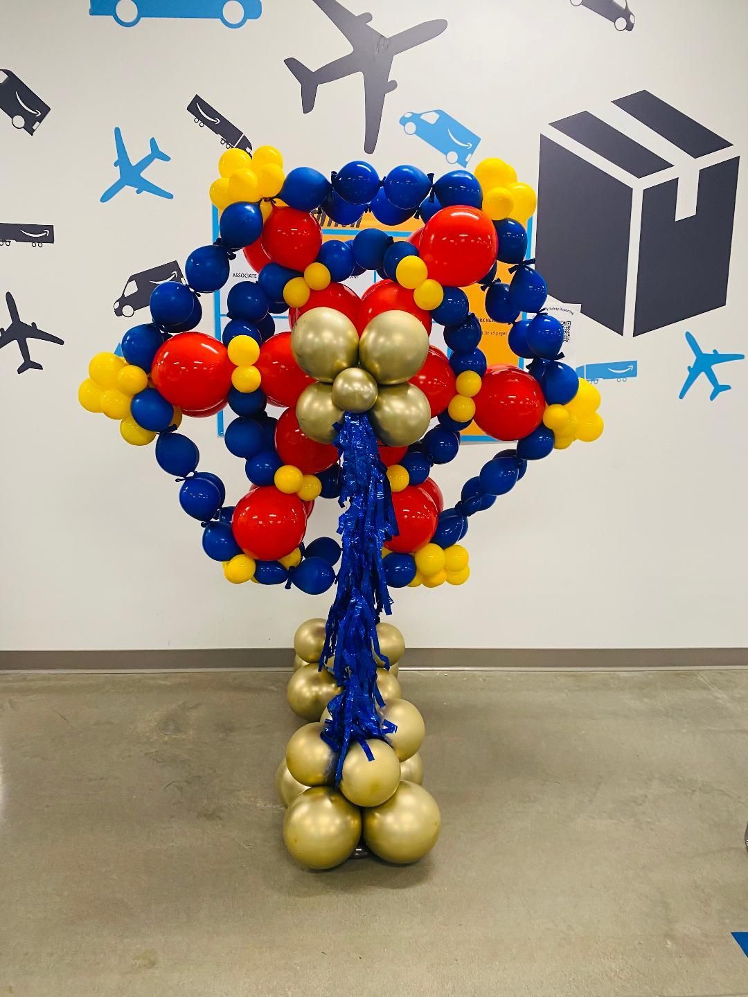 A tree made of red yellow and blue balloons