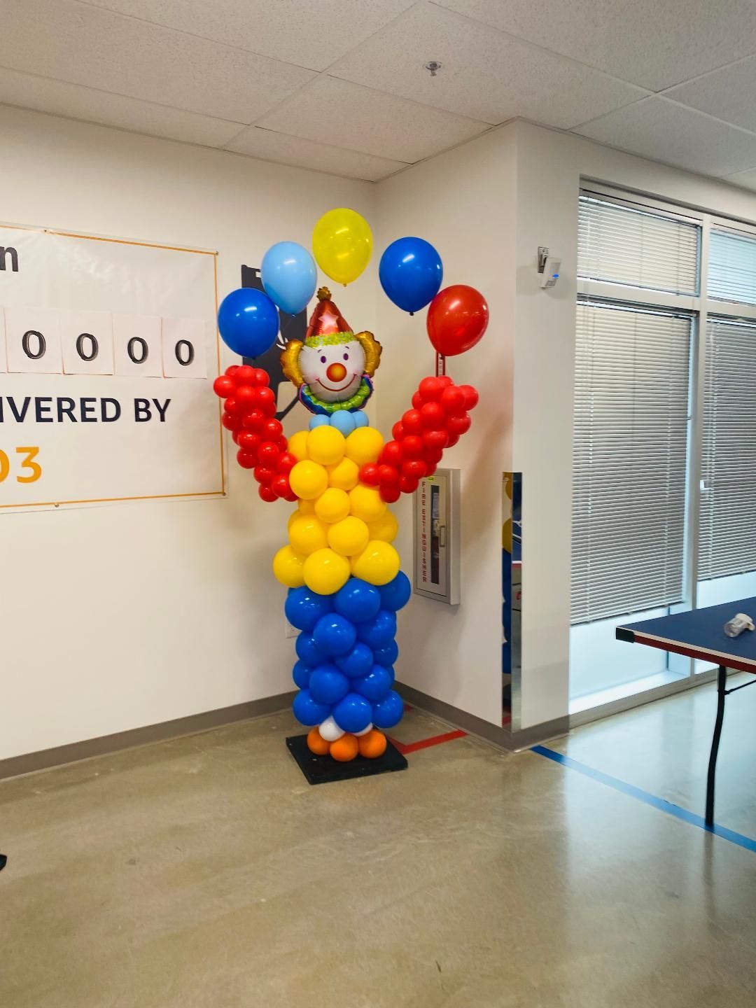 A clown made out of balloons in a room