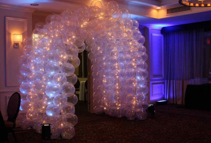 A room filled with lots of balloons and lights.