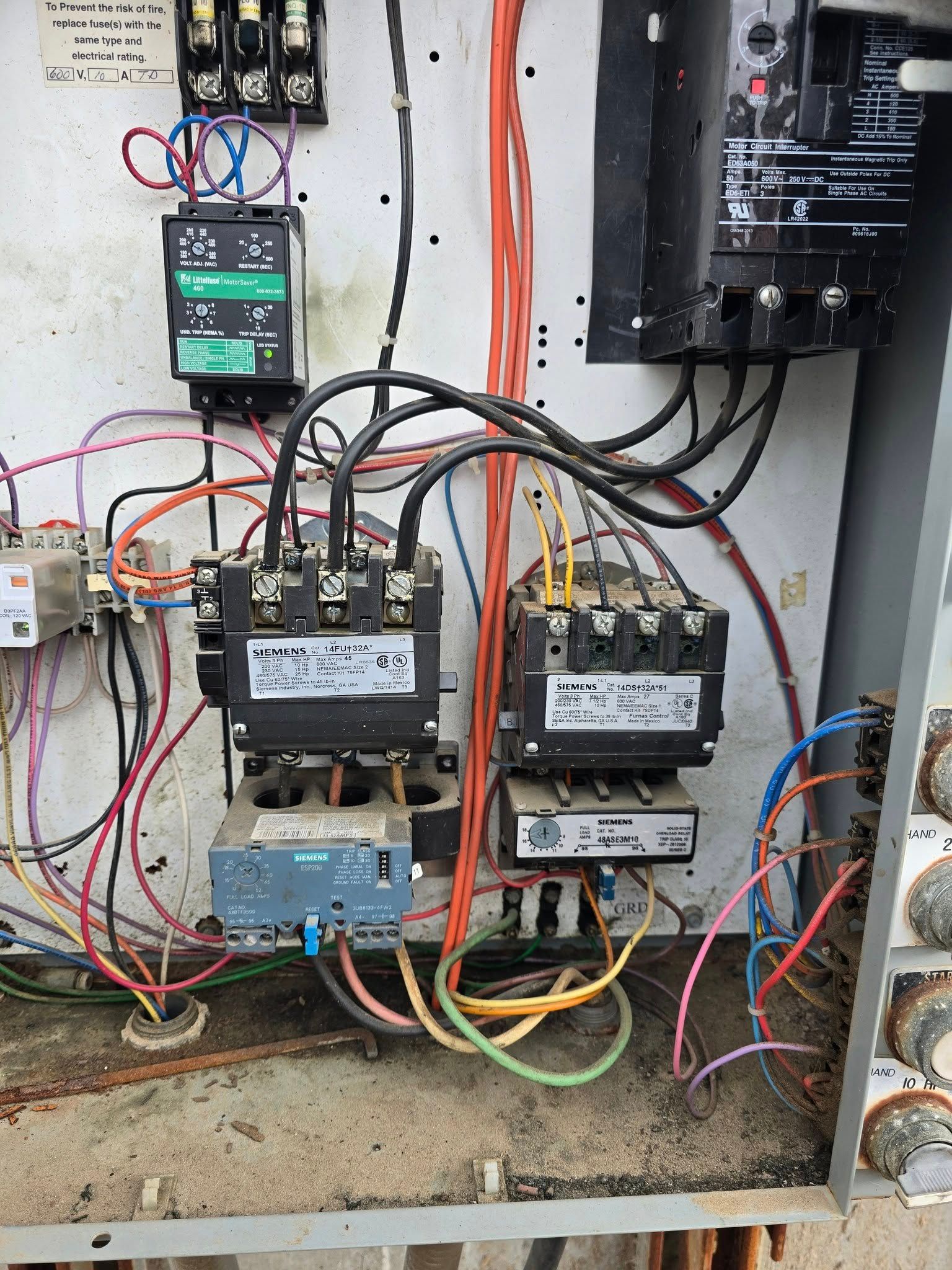 Electrical control panel with multiple relays and wiring.