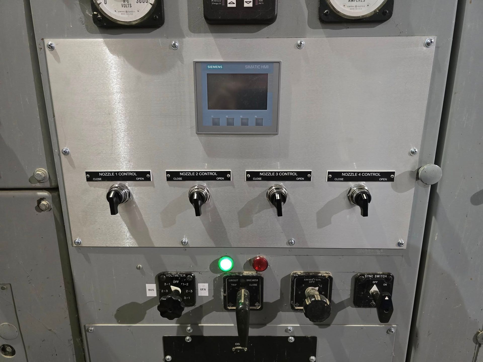 Control panel with gauges, switches, and a digital display.