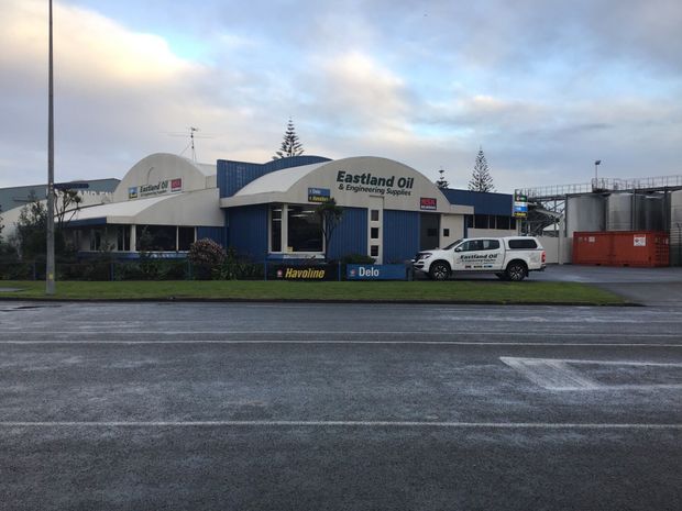 Man is checking the motor engine oil of his car in Gisborne