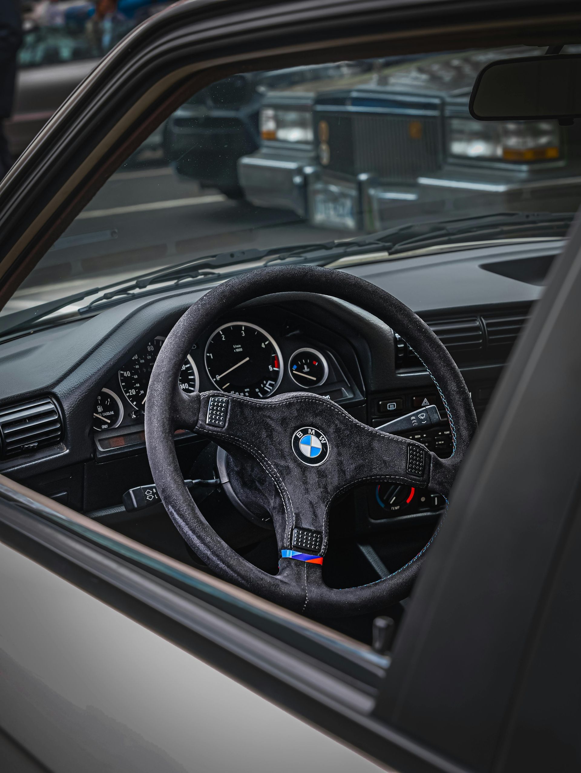 A close up of a steering wheel in a car.