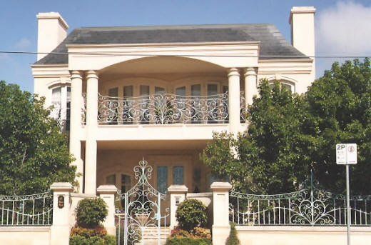 large home with ornate fencing