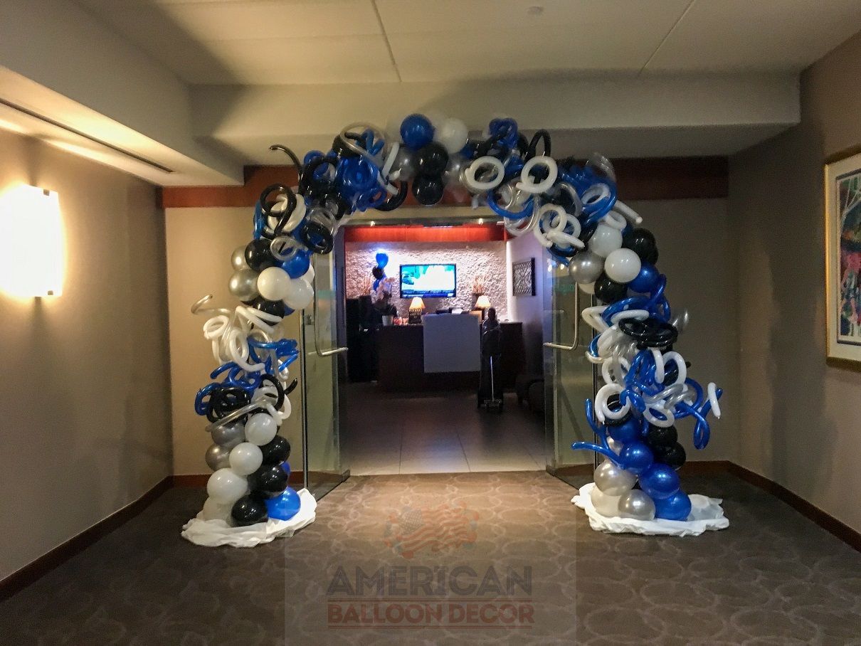 A hallway with a balloon arch in the middle of it