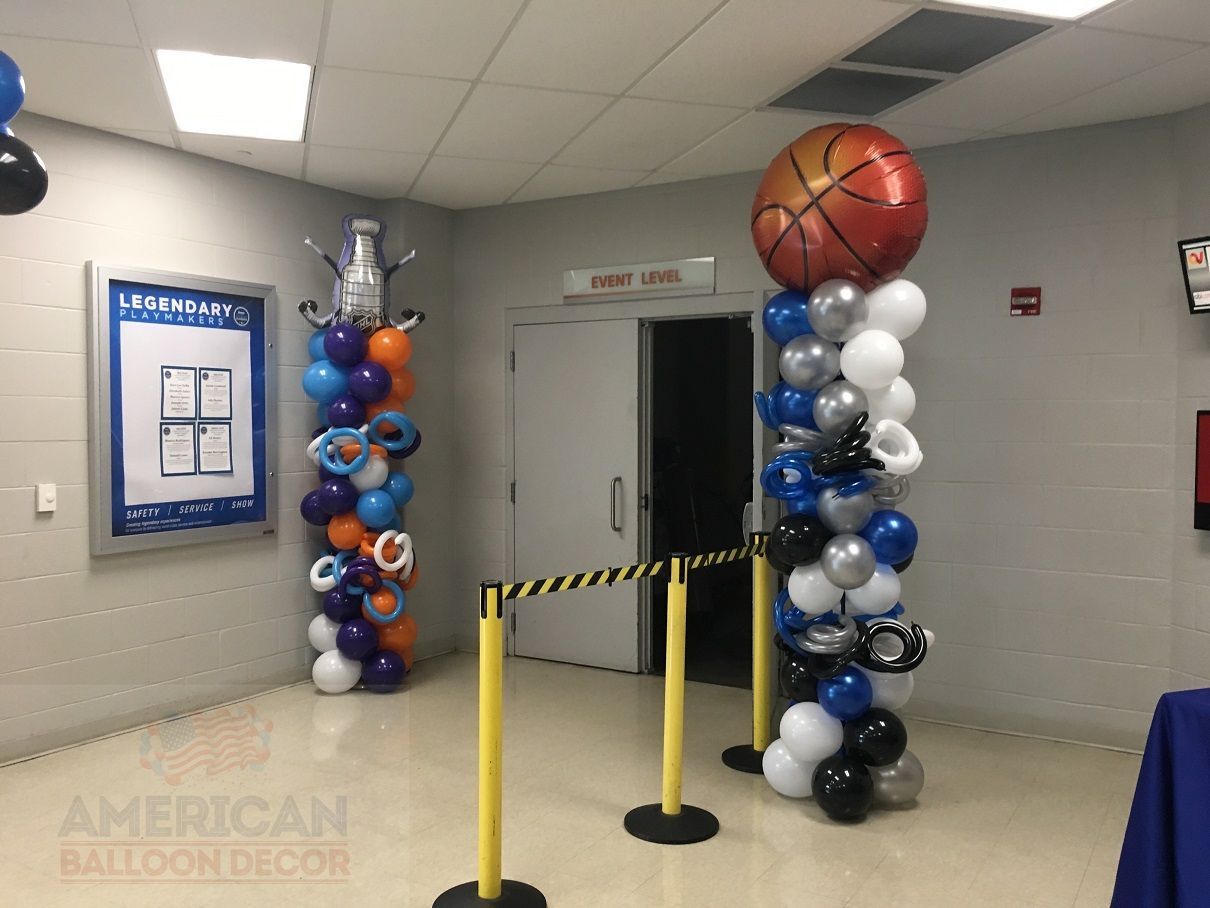 A hallway decorated with balloons and a basketball.
