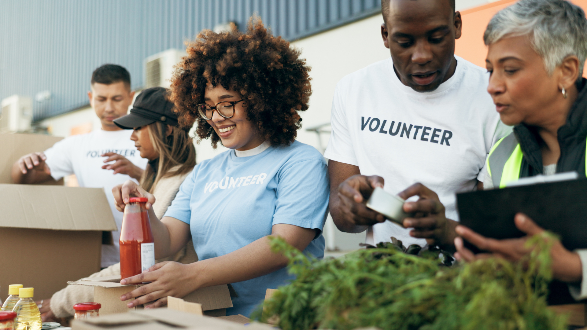 A group of volunteers are standing around a table.
