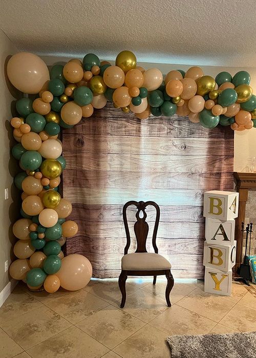 A room decorated with balloons and a chair.