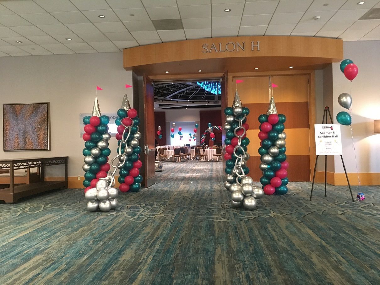 A hallway with balloons and a sign that says block ii