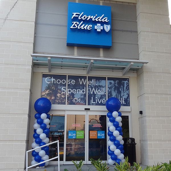 The front of a florida blue store with blue and white balloons