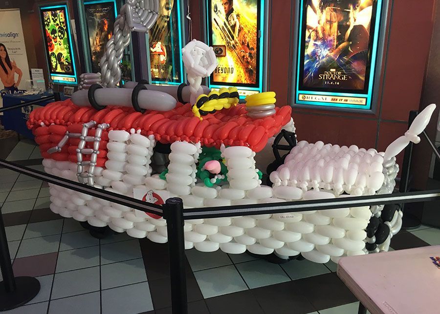 A boat made out of balloons in a movie theater.