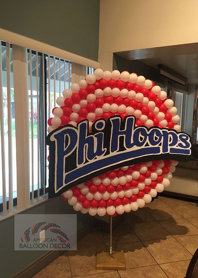 A sign made of red and white balloons that says phil hoops