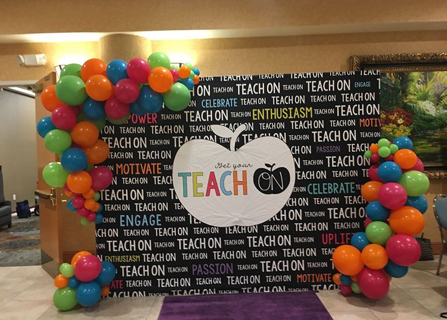 A bunch of balloons with the word teach on them