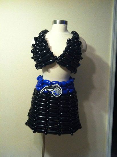 A black and blue dress made of balloons on a mannequin