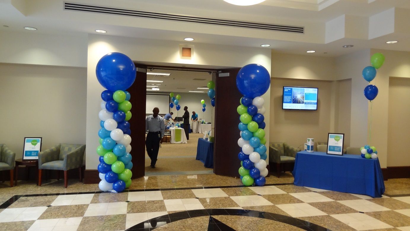 A hallway decorated with blue and green balloons