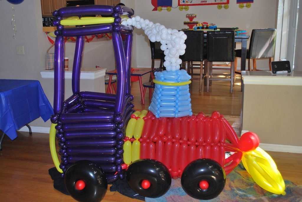 A train made out of balloons in a room