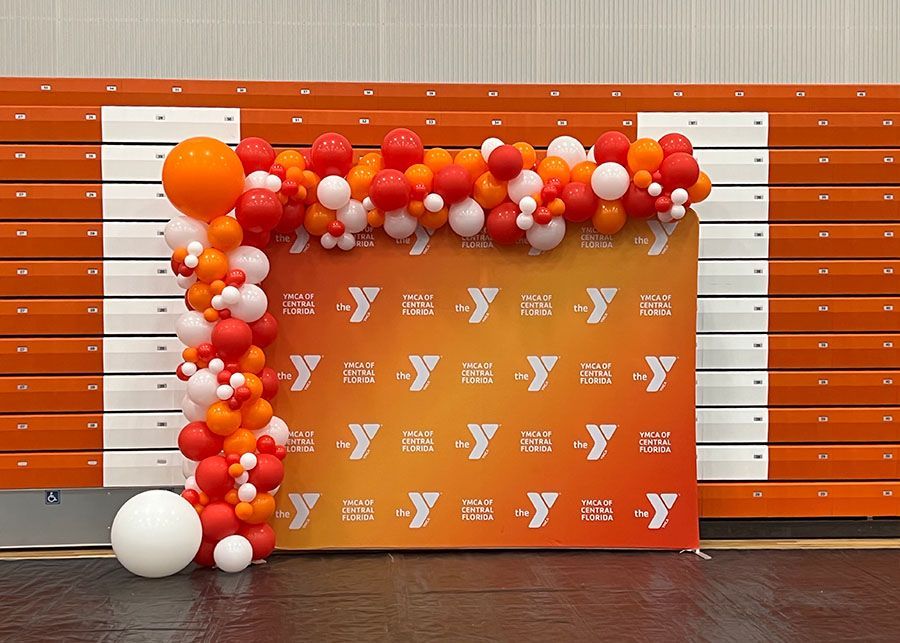 A wall with balloons and a sign that says y on it