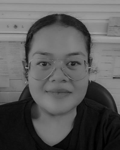 A black and white photo of a woman wearing glasses and a black shirt.