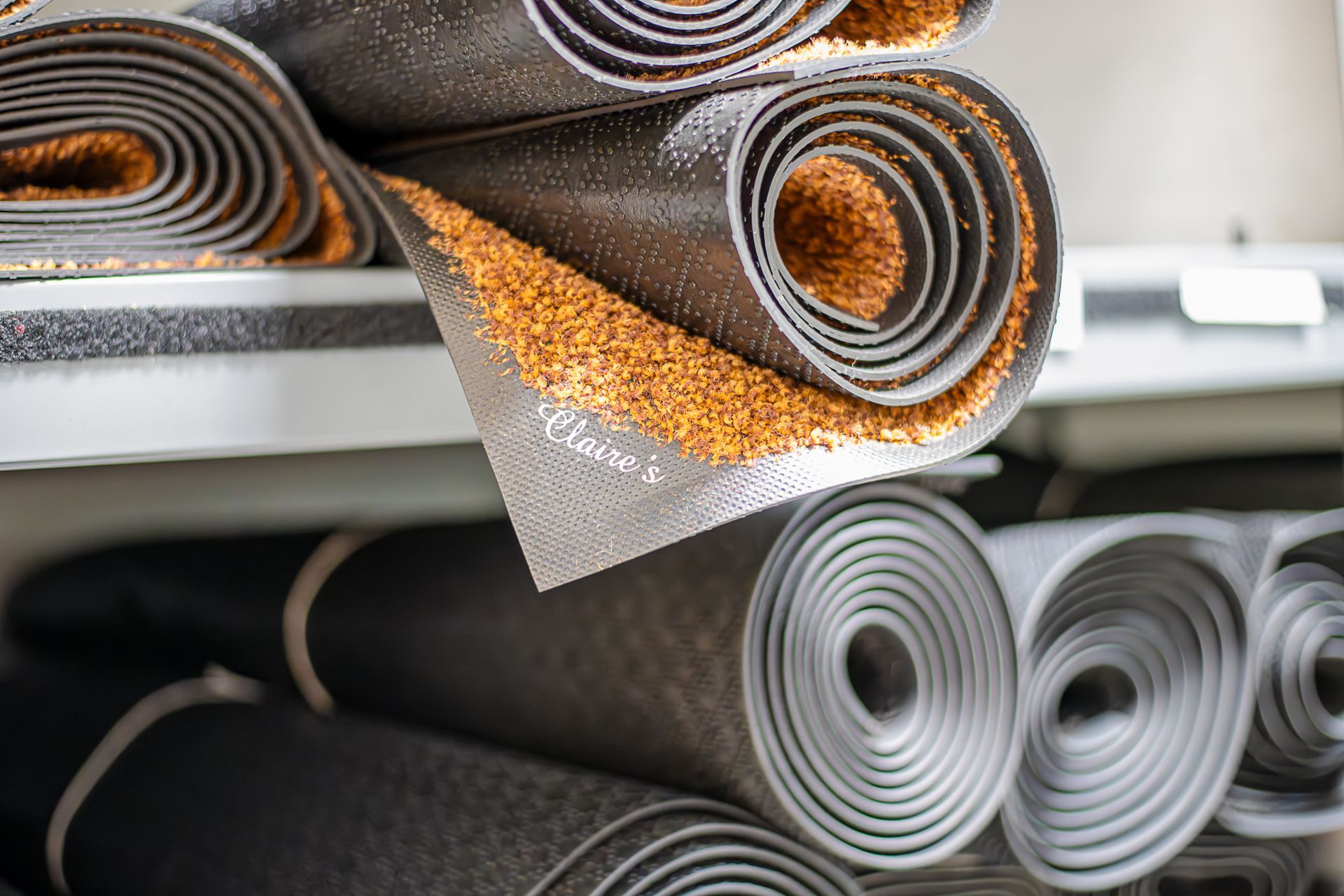 Rugs rolled up on a shelf