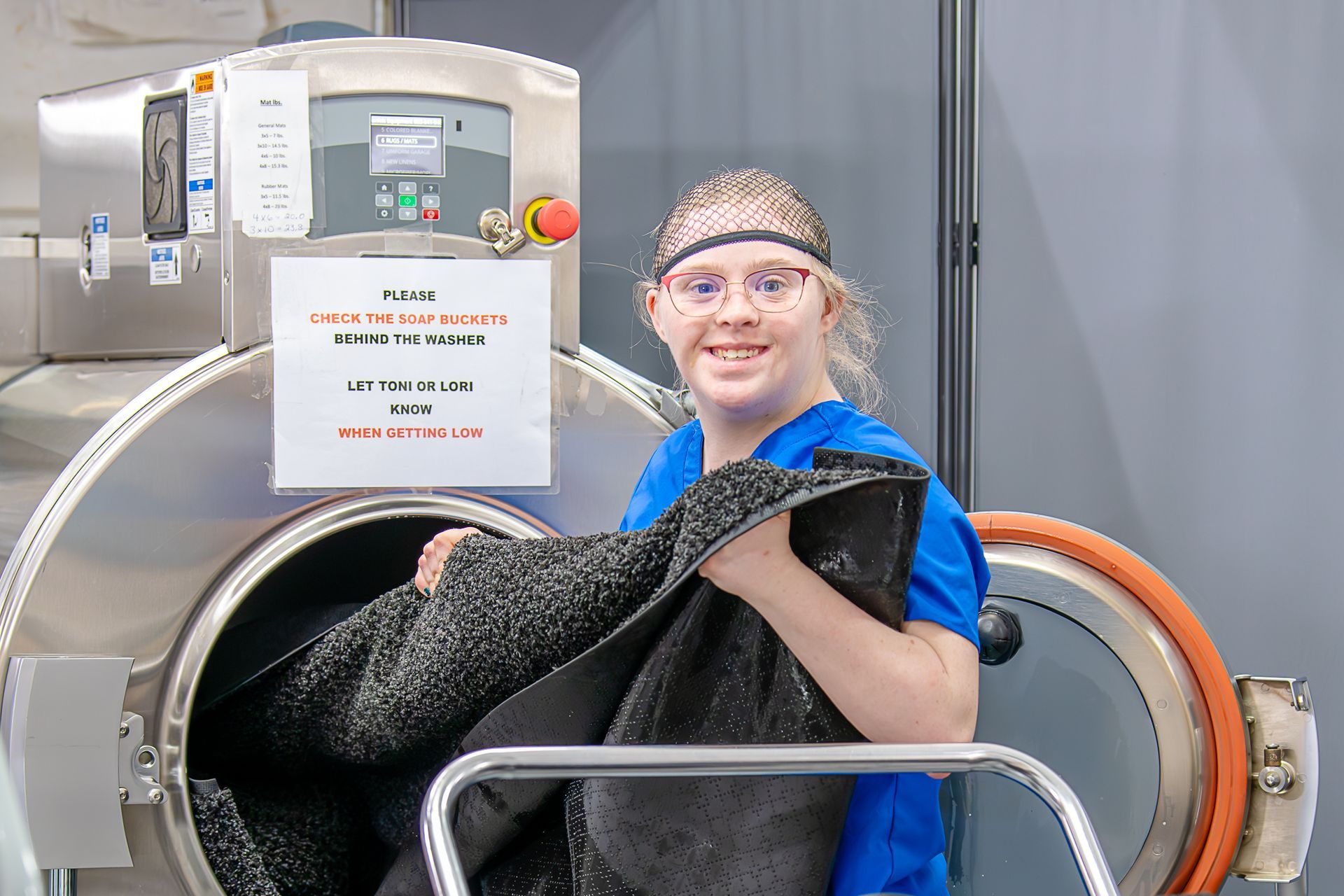 Claire's employee removing a run from the lauding machine