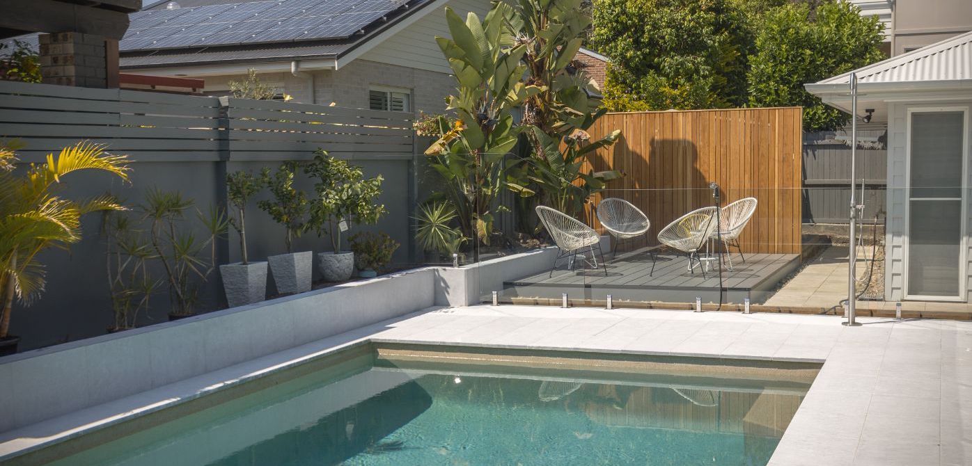 A White Truck Is Parked In Front Of A Large House — Beach Breeze Building In Tumbi Umbi, NSW