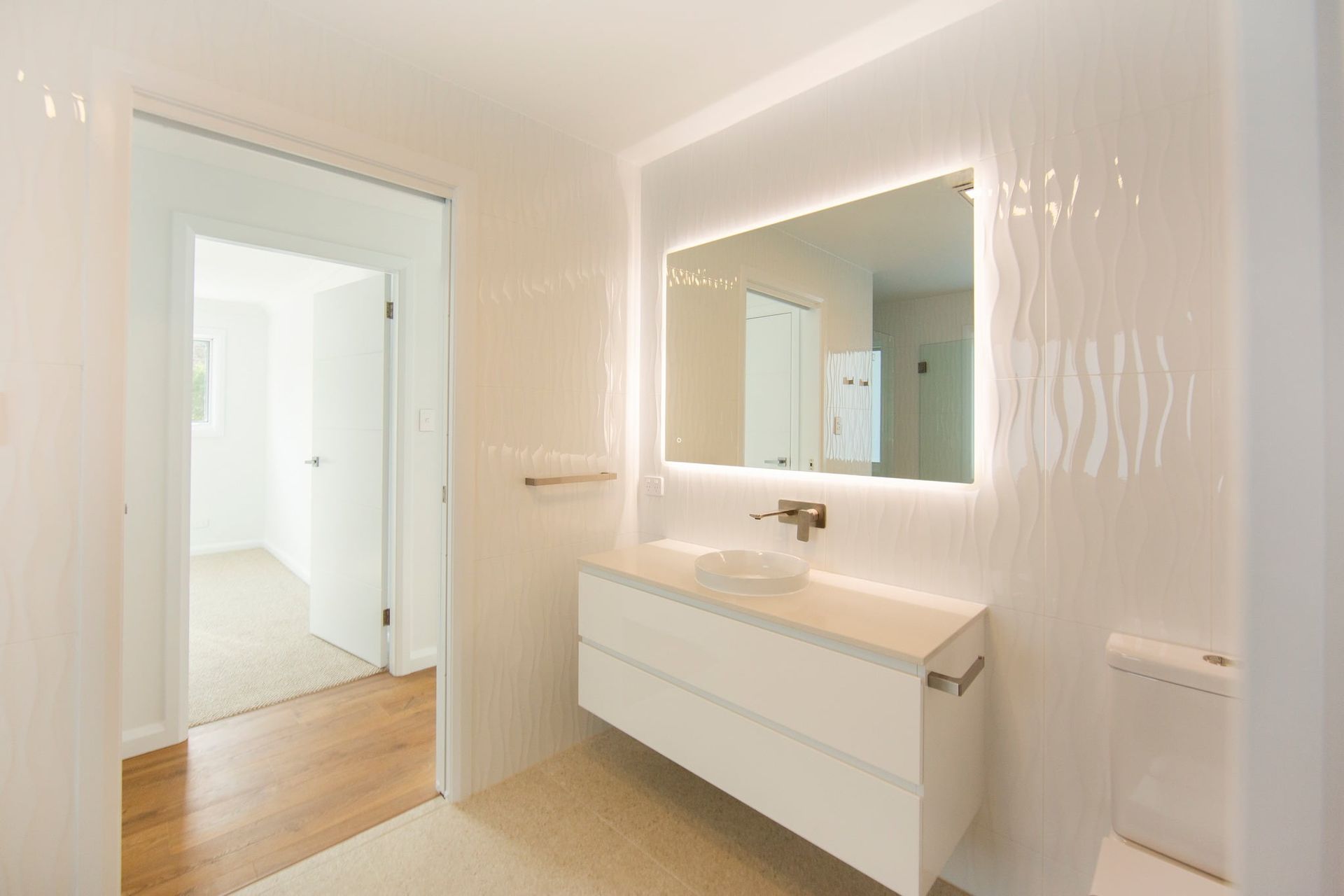 A Man Is Standing In Front Of A Building Under Construction — Beach Breeze Building In Tumbi Umbi, NSW