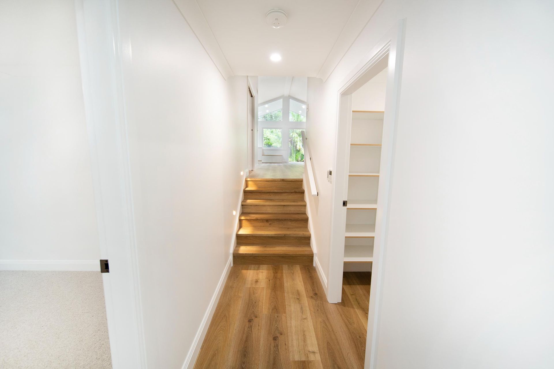 A Hallway With Stairs Leading Up to the Second Floor of a House — Beach Breeze Building In Tumbi Umbi, NSW