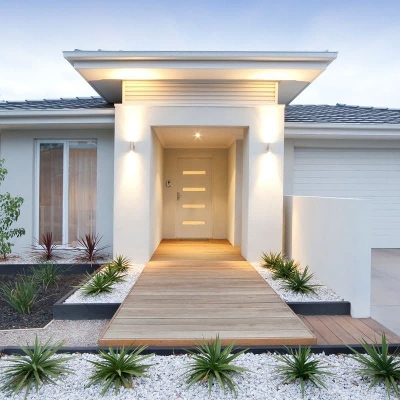 A White House With A Wooden Walkway Leading To The Front Door — Beach Breeze Building In Tumbi Umbi, NSW